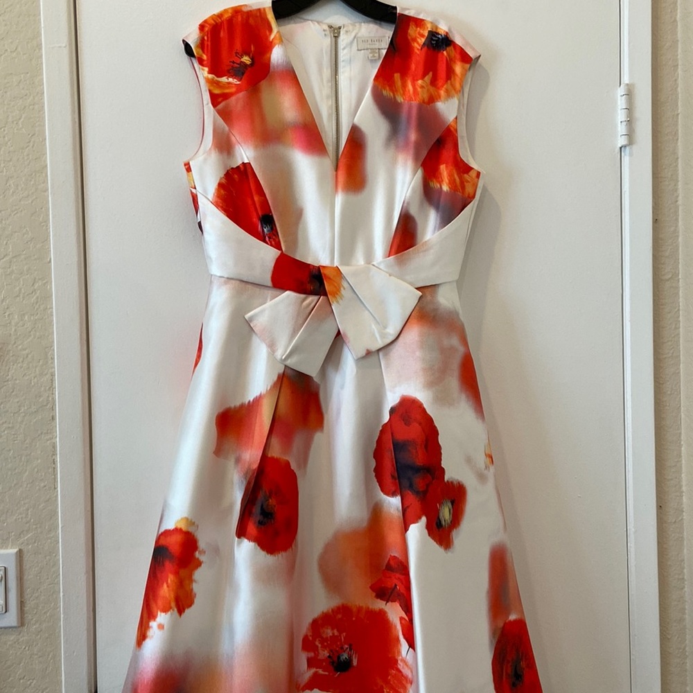 A Ted Baker Size 3 Tea length dress with a matching clutch.